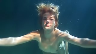 Curvaceous Russian takes down her clothes while under the water