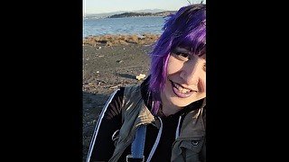 Alternative girl smoking cigarettes on the beach