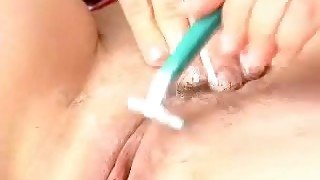 Buxom girlfriend shaves her hairy cunt in front of me